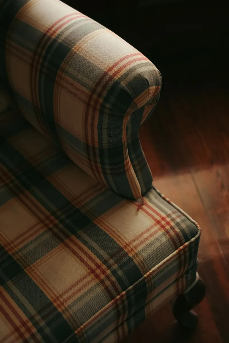Close-up of a green tartan armchair.
